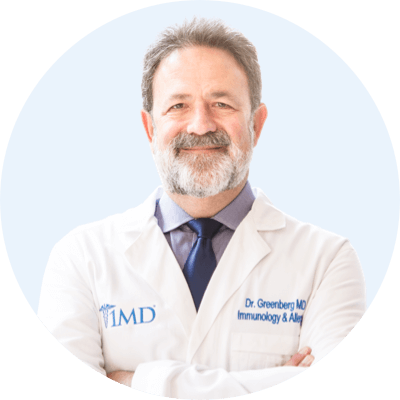 Dr. Greenberg portrait in a blue circle