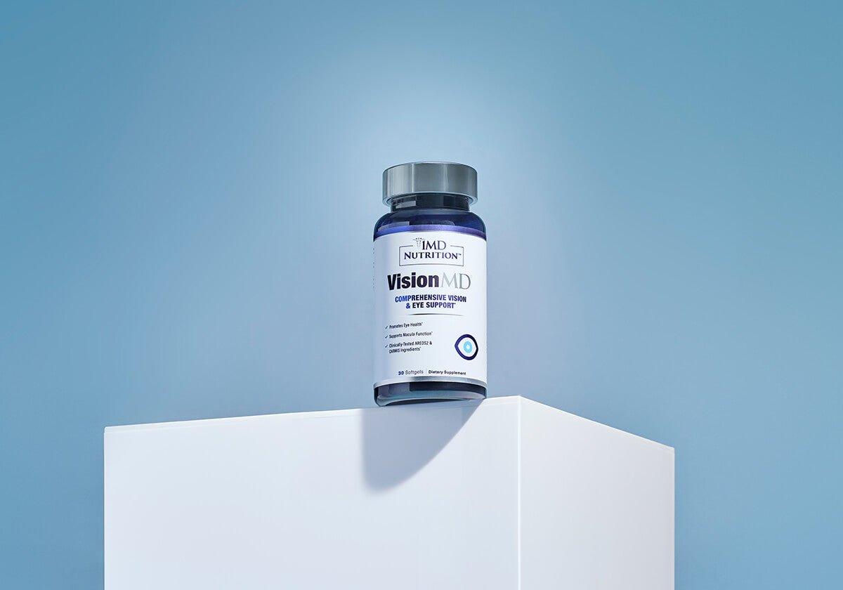VisionMD by 1MD Nutrition bottle for comprehensive vision and eye support displayed on white platform against blue background